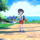 A Pokémon trainer stands on a sunny street in Scarlet and Violet.